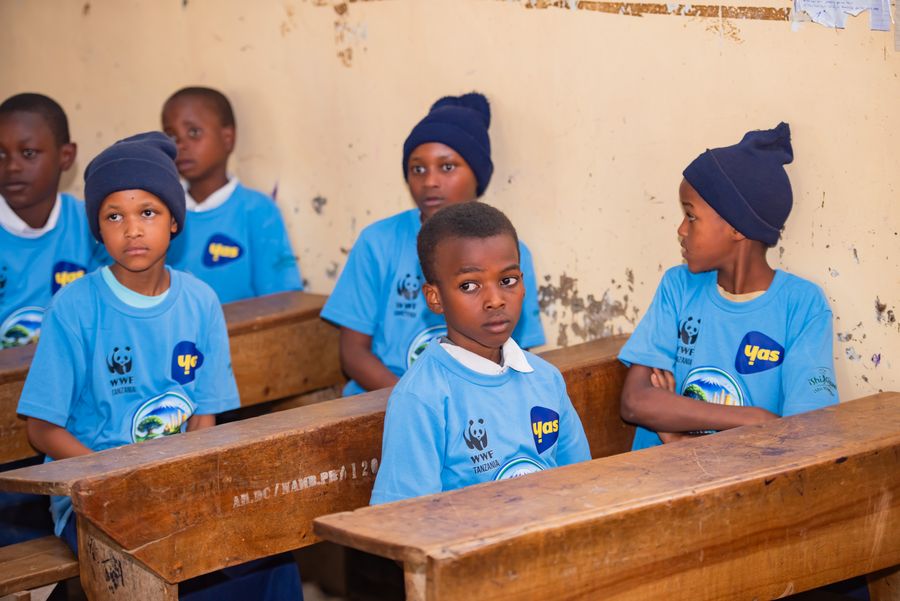 Students in KIWI water education shirts listening from their desks during a classroom session