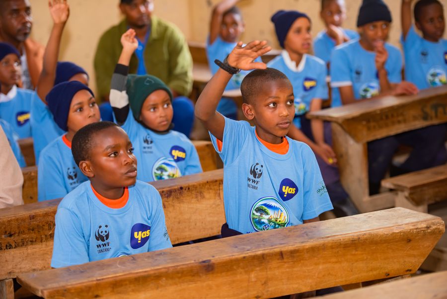 Students raising their hands to answer during a KIWI water education lesson